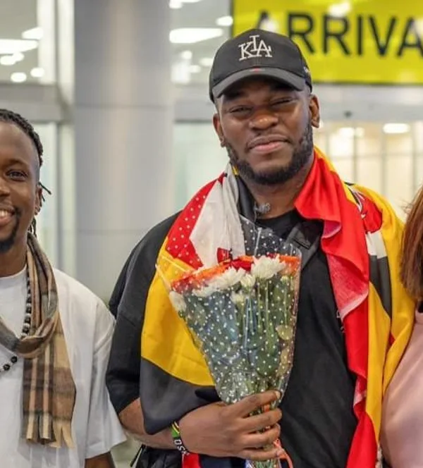 Nonso Amadi flanked by Watala and Lynda Ddane shortly after his arrival at Entebbe International Airport