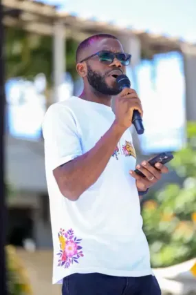 Head of Programs at Reach a Hand Uganda, Benson Muhindo at the event
