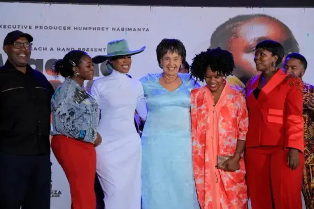 Maggie Kigozi takes a photo with guests