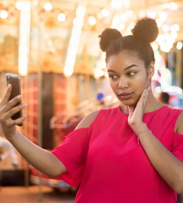 brown-african-woman-in-red-shirt-taking-selfie